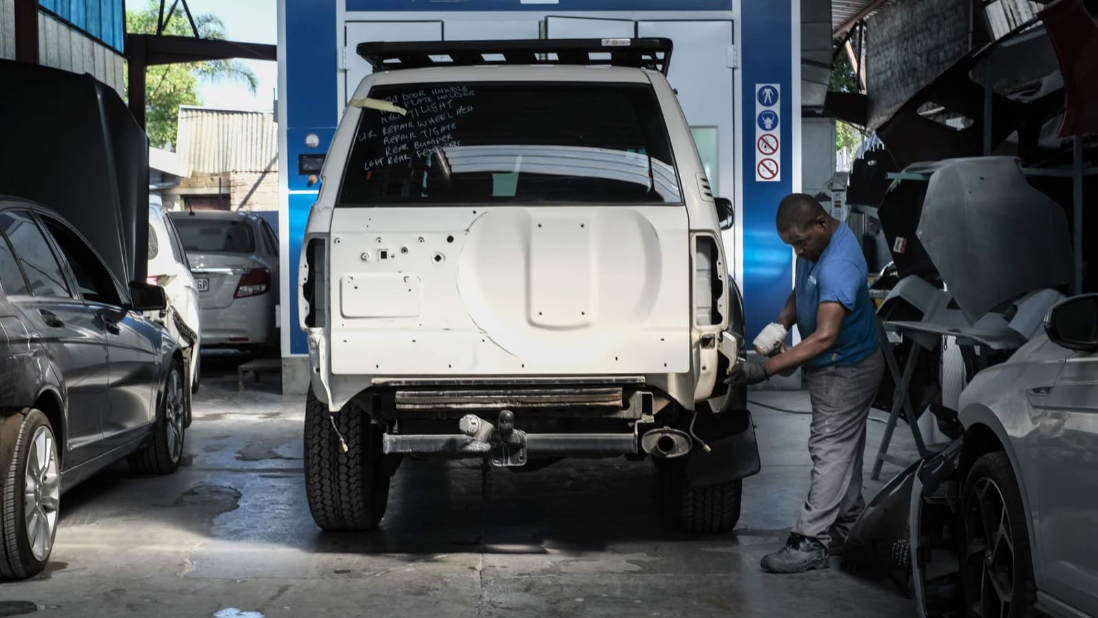 Collision-damaged SUV being repaired